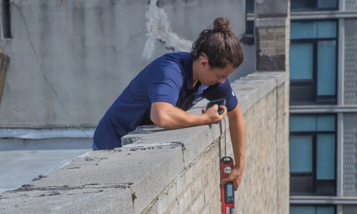 engineer inspecting parapet