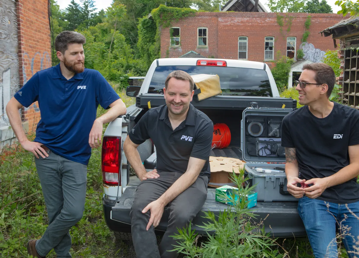 Team in truck bed with environmental supplies